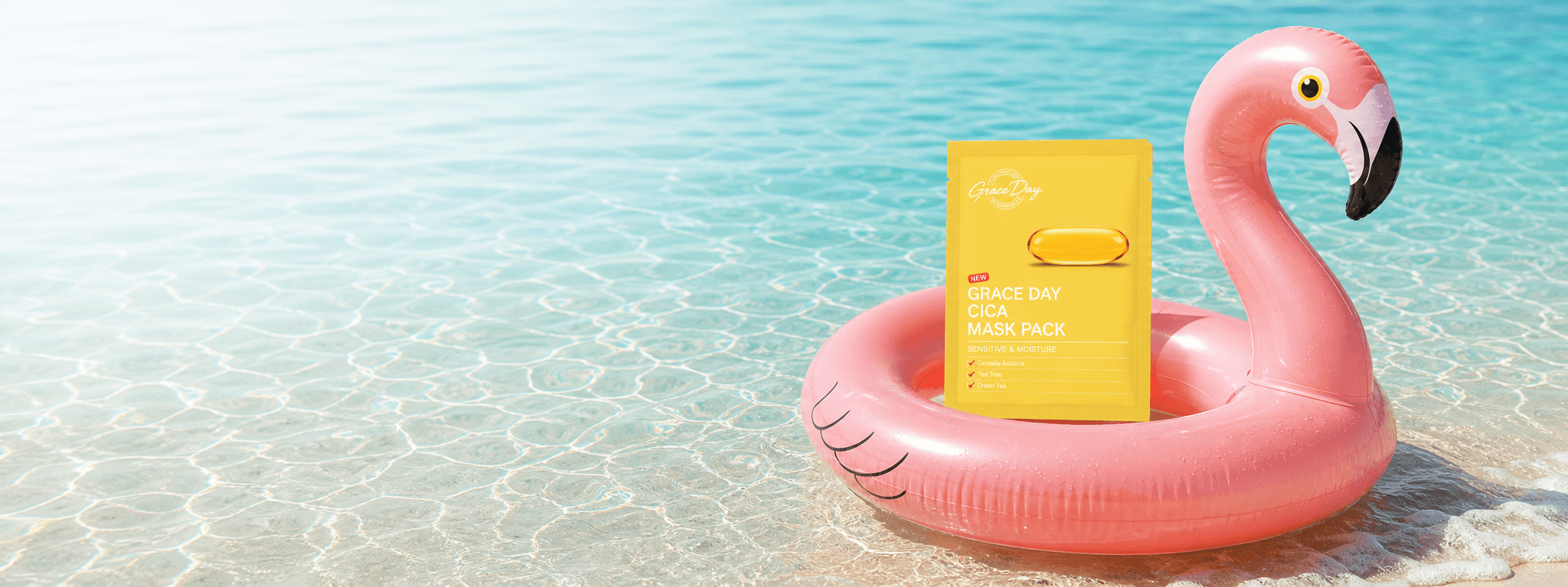 Grace Day Cica mask pack on a pink flamingo tube in clear beach water